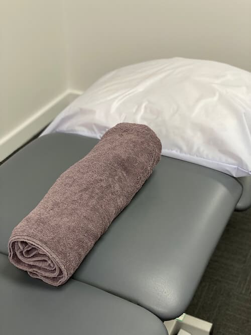 A rolled towel can be used for thoracic spine stretching
