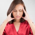 Woman holding her head suffering from dizziness looking for physiotherapy in Adelaide for help