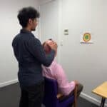 Vestibular physio assisting with neck rehab in a dizzy patient