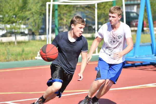 two teenagers playing competitive basketball at risk of ankle injury