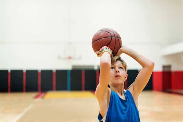 adolescent boy training for basketball working on basketball injury prevention