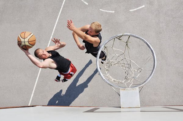 two young men contesting for basketball one on one